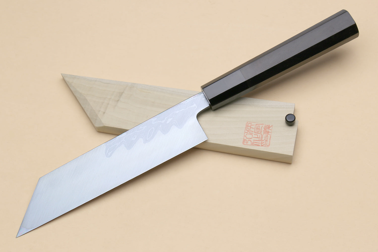 Japanese vegetable knife with light blue patterned blade and black handle; includes wooden saya
