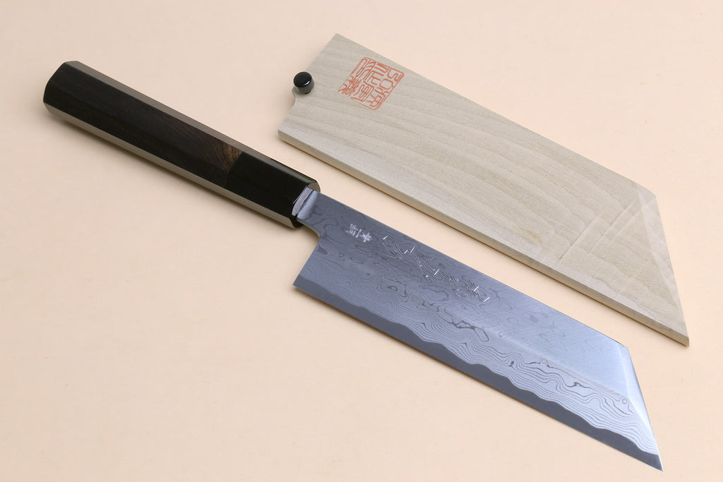 Japanese vegetable knife with blue-steel patterned blade, black handle, and light wood saya