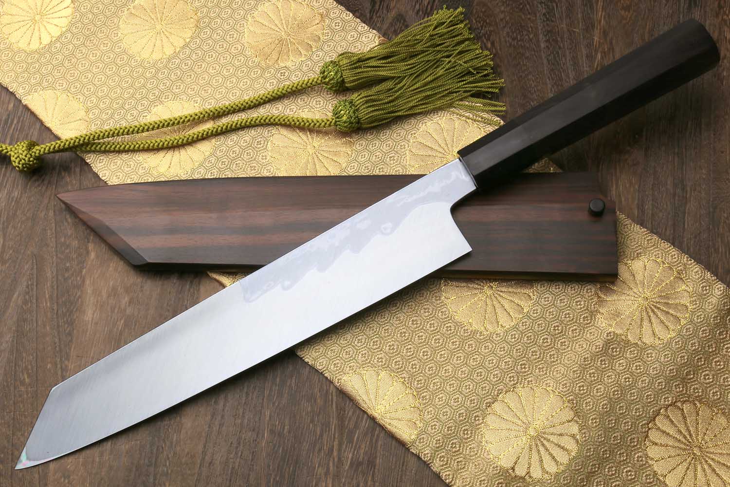 Kiritsuke knife with damascus blade and dark wood saya, green tassel, ebony handle