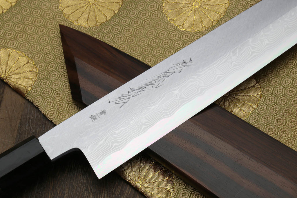 Damascus Kiritsuke chef knife blade with etched pattern and ebony handle