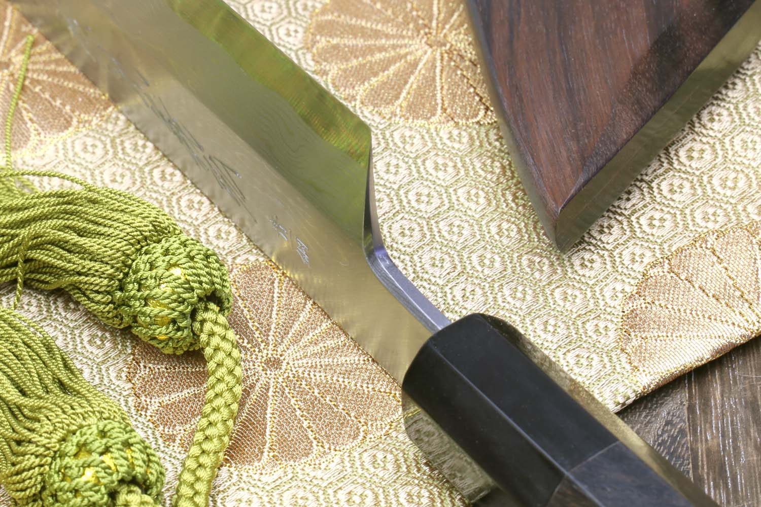 Kiritsuke Japanese chef knife showing damascus steel blade and ebony handle