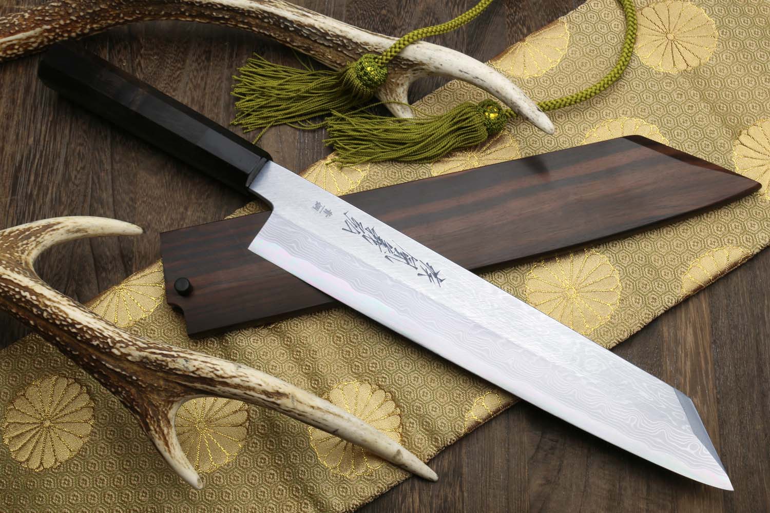Kiritsuke Japanese chef knife with damascus blade, ebony handle, and green cord tassel