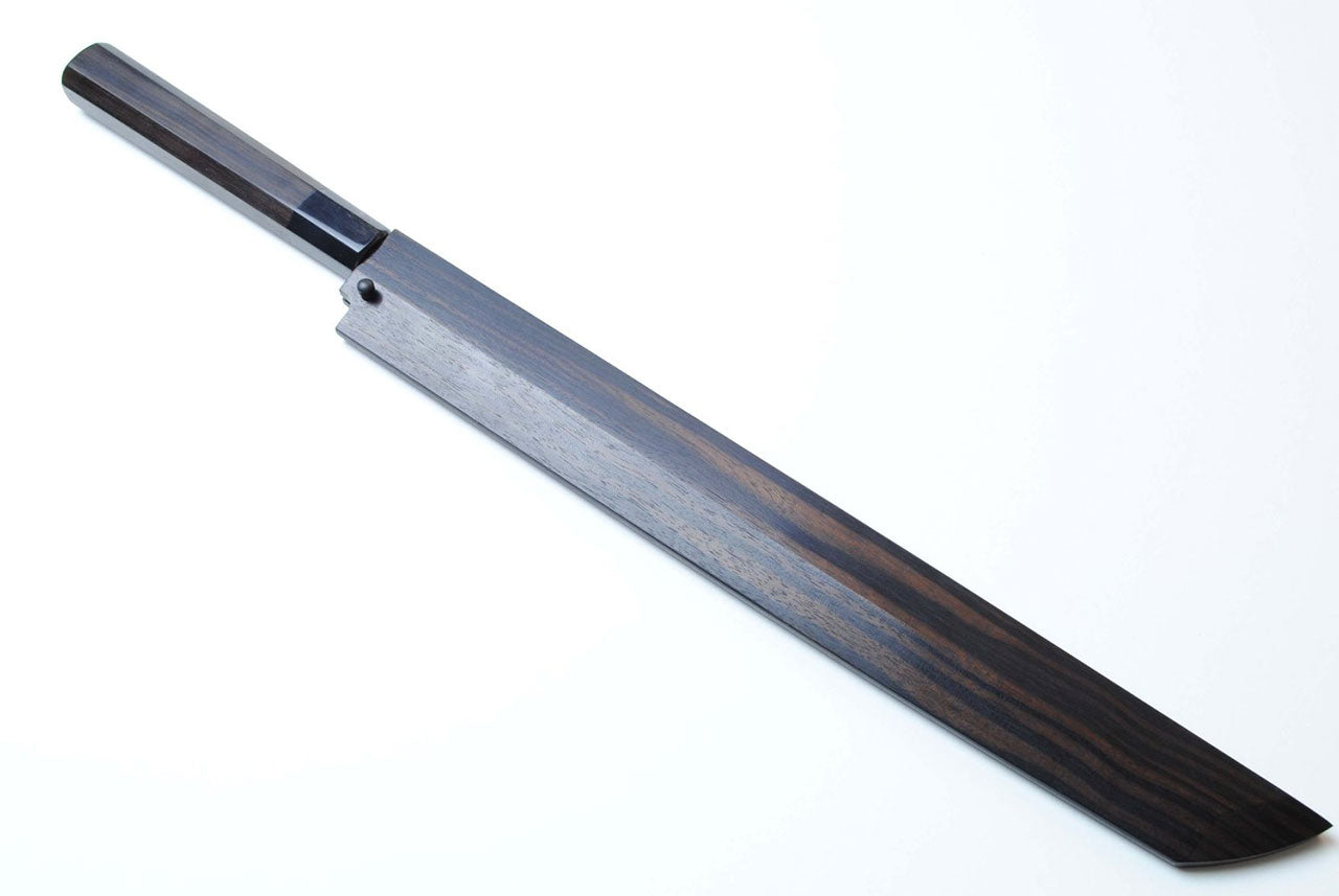 Japanese chef knife with Damascus-style blade and dark ebony wood handle, tip view