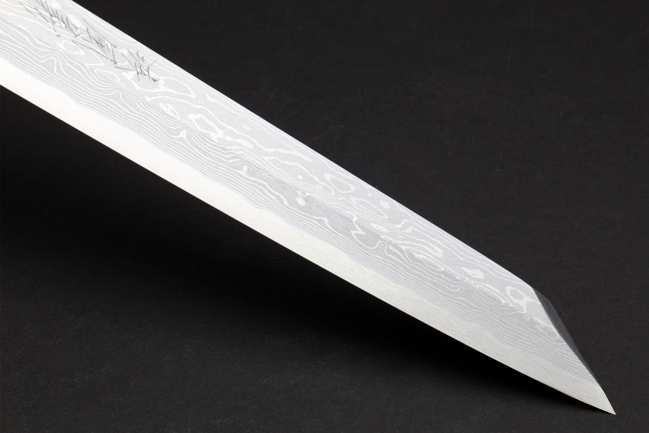 Japanese yanagi sushi knife close-up of pointed damascus blade