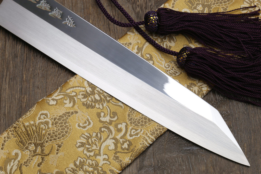 Kiritsuke Japanese knife with mirror-finished single-edge blade and dark handle