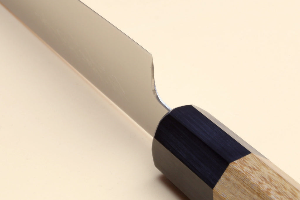 Petty utility knife blade with stainless steel finish and wood handle with dark spacer