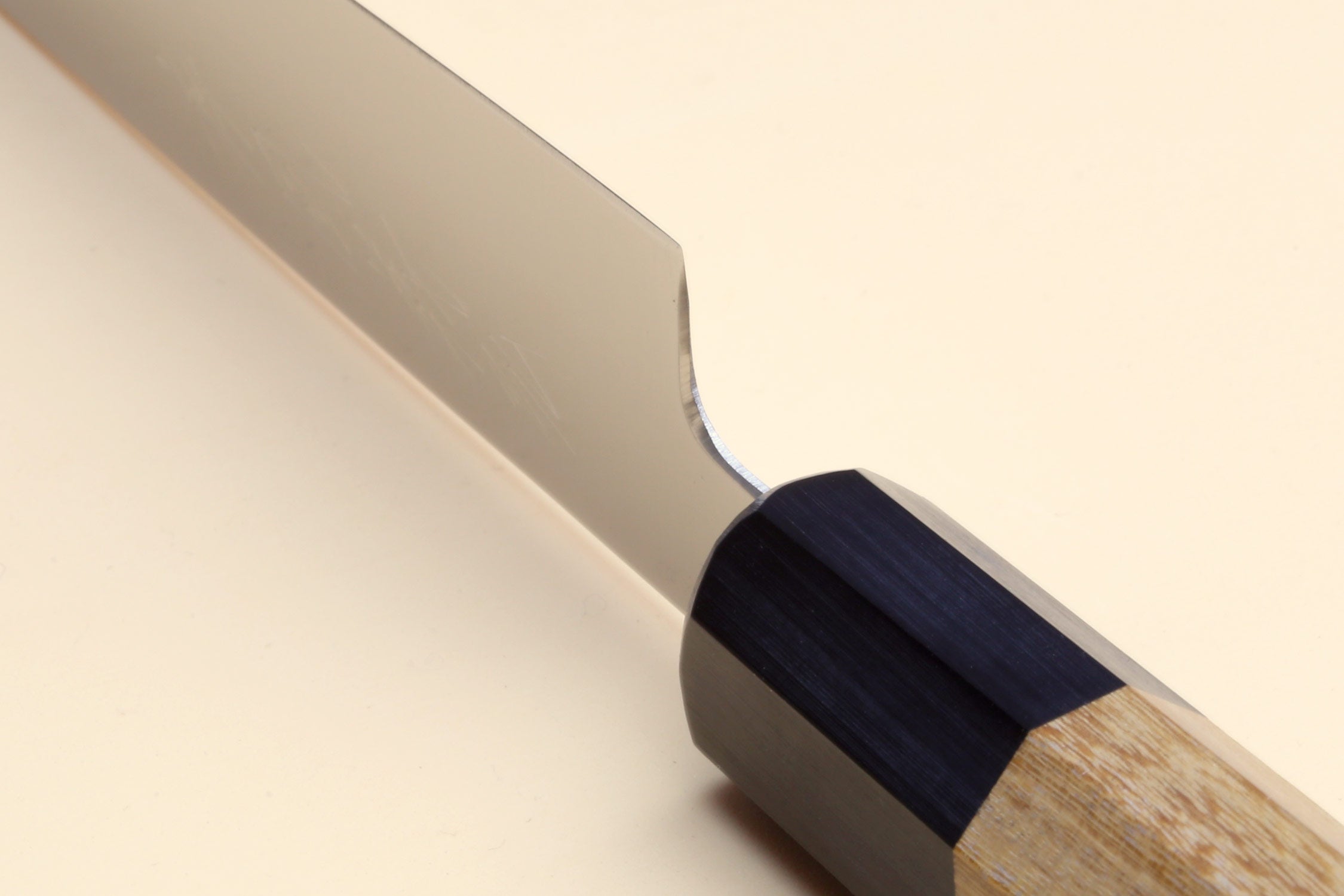 Petty utility knife blade with stainless steel finish and wood handle with dark spacer