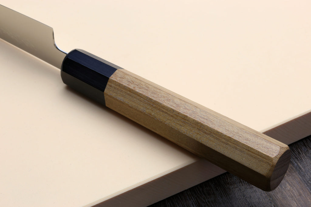 Petty utility knife with stainless blade and wood handle with dark spacer