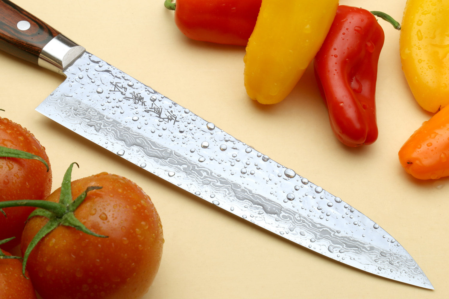 Damascus-style chef knife with pointed blade and dark wood handle
