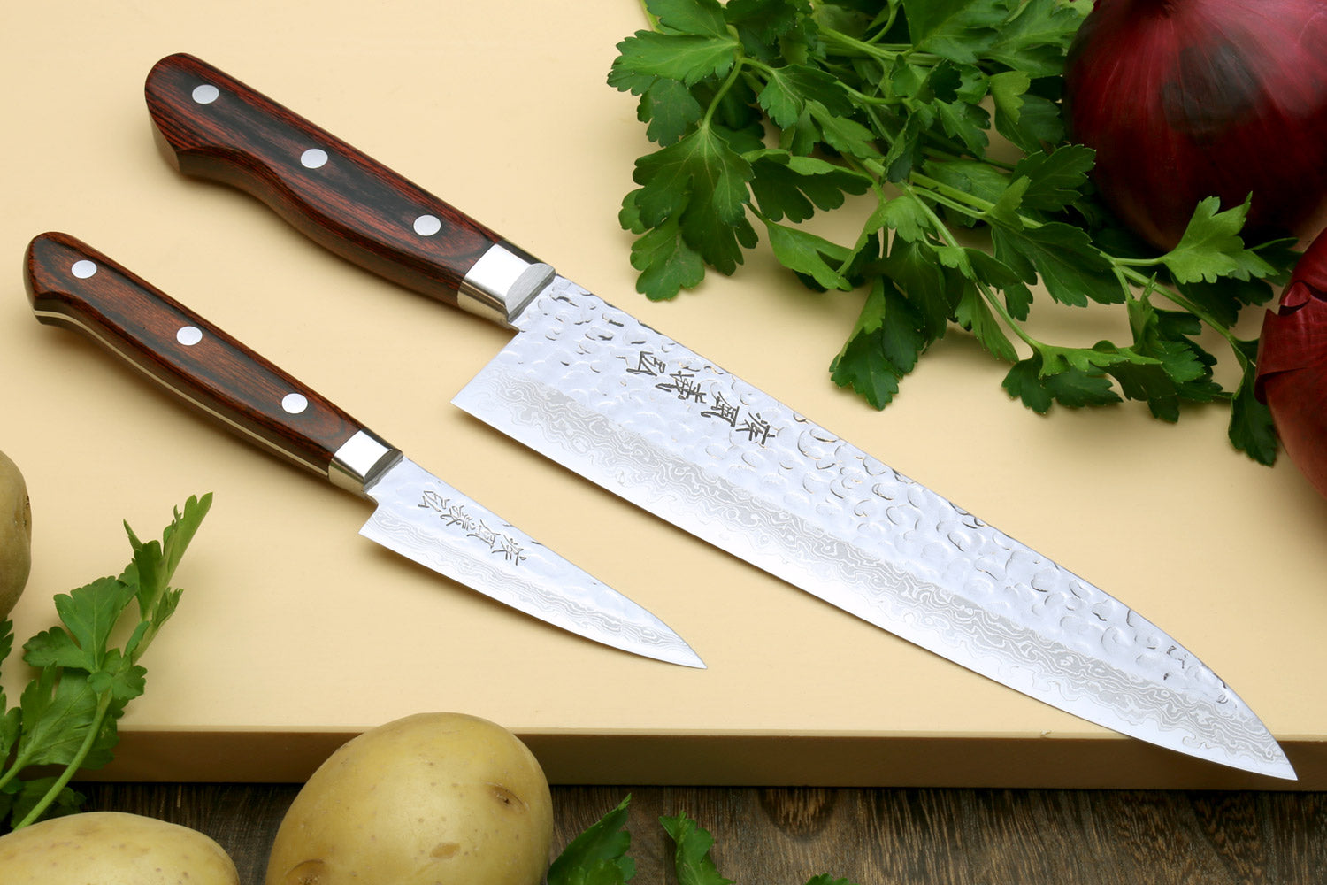 Yoshihiro hammered Damascus gyuto and paring knives with dark wooden handles