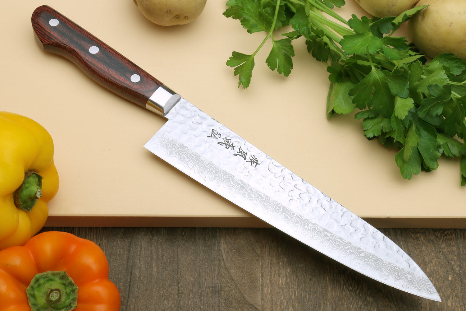 Damascus gyuto chef knife with hammered silver blade and dark wood handle