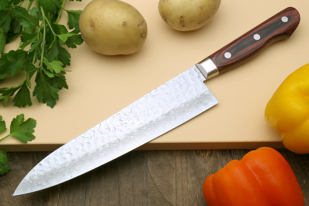 Damascus gyuto chef knife with hammered silver blade and dark wood handle