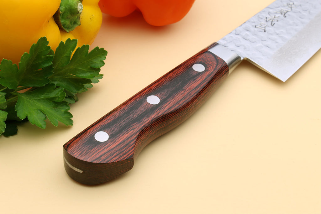 Damascus gyuto chef knife handle with dark wood scales and three silver rivets