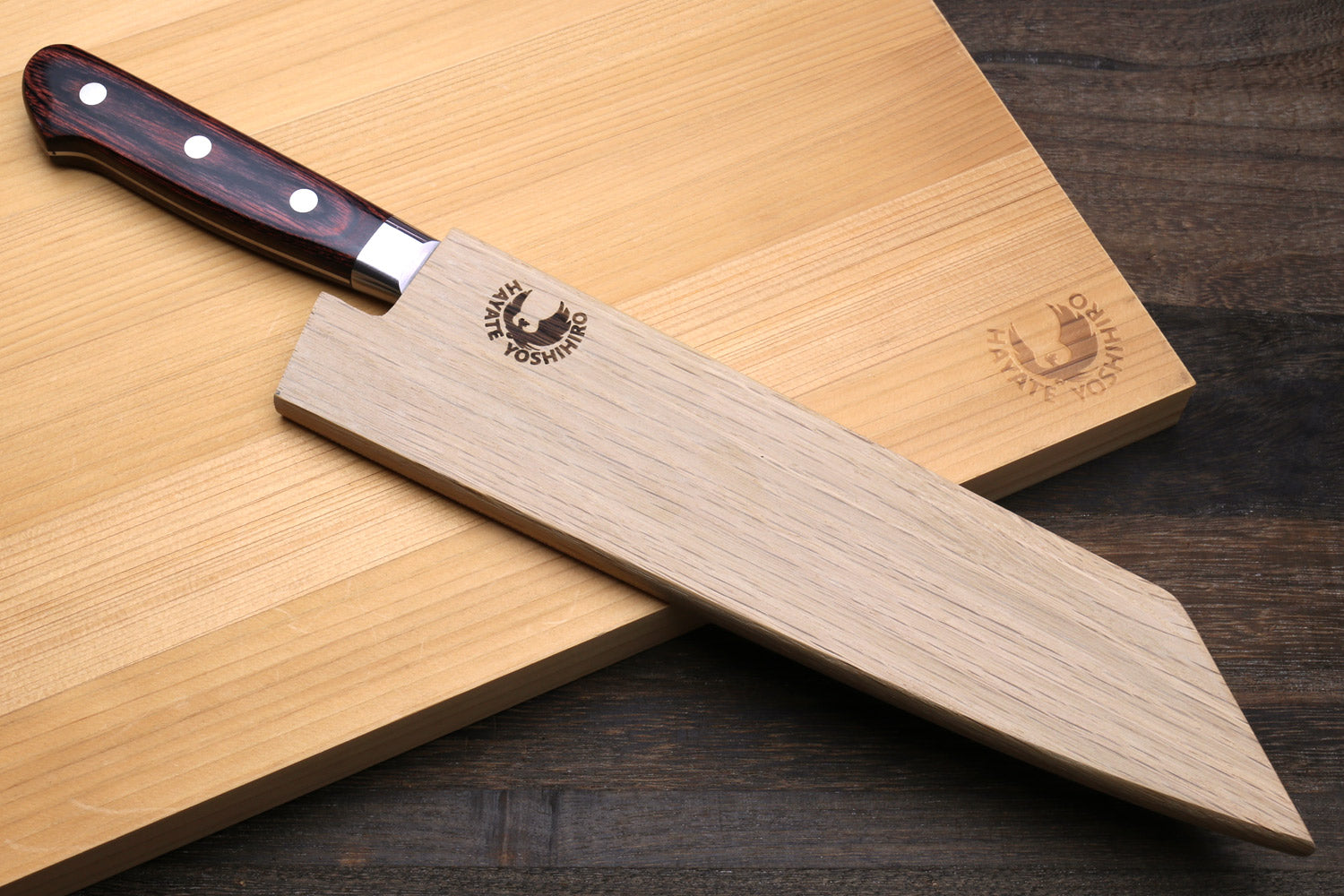 Kiritsuke multipurpose knife with hammered Damascus blade and dark wood handle