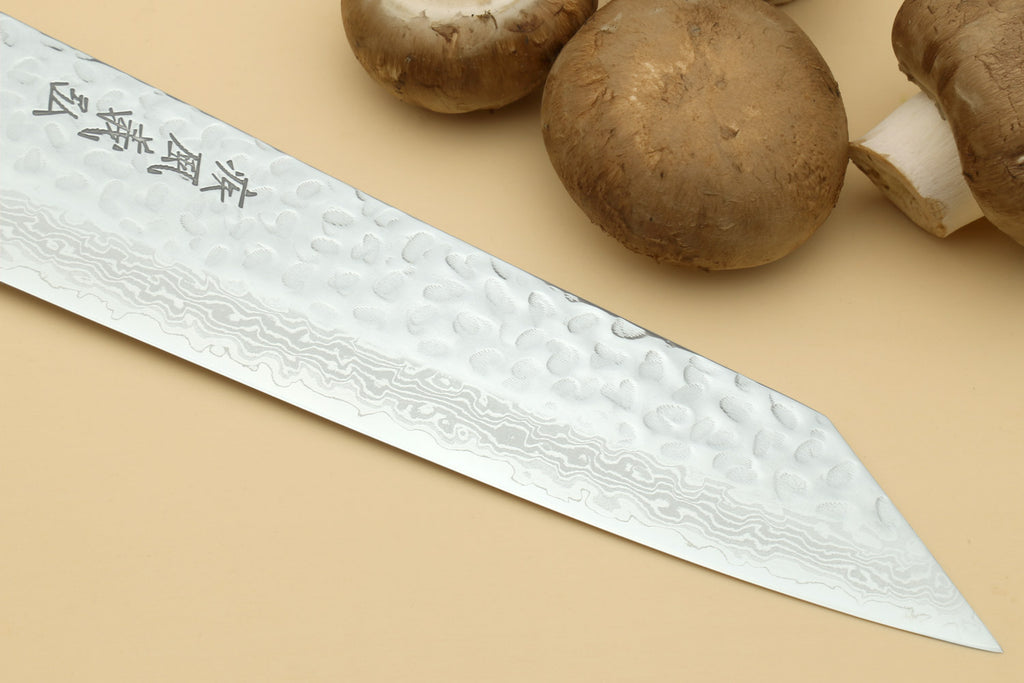 Kiritsuke knife showing hammered Damascus blade with engraved characters