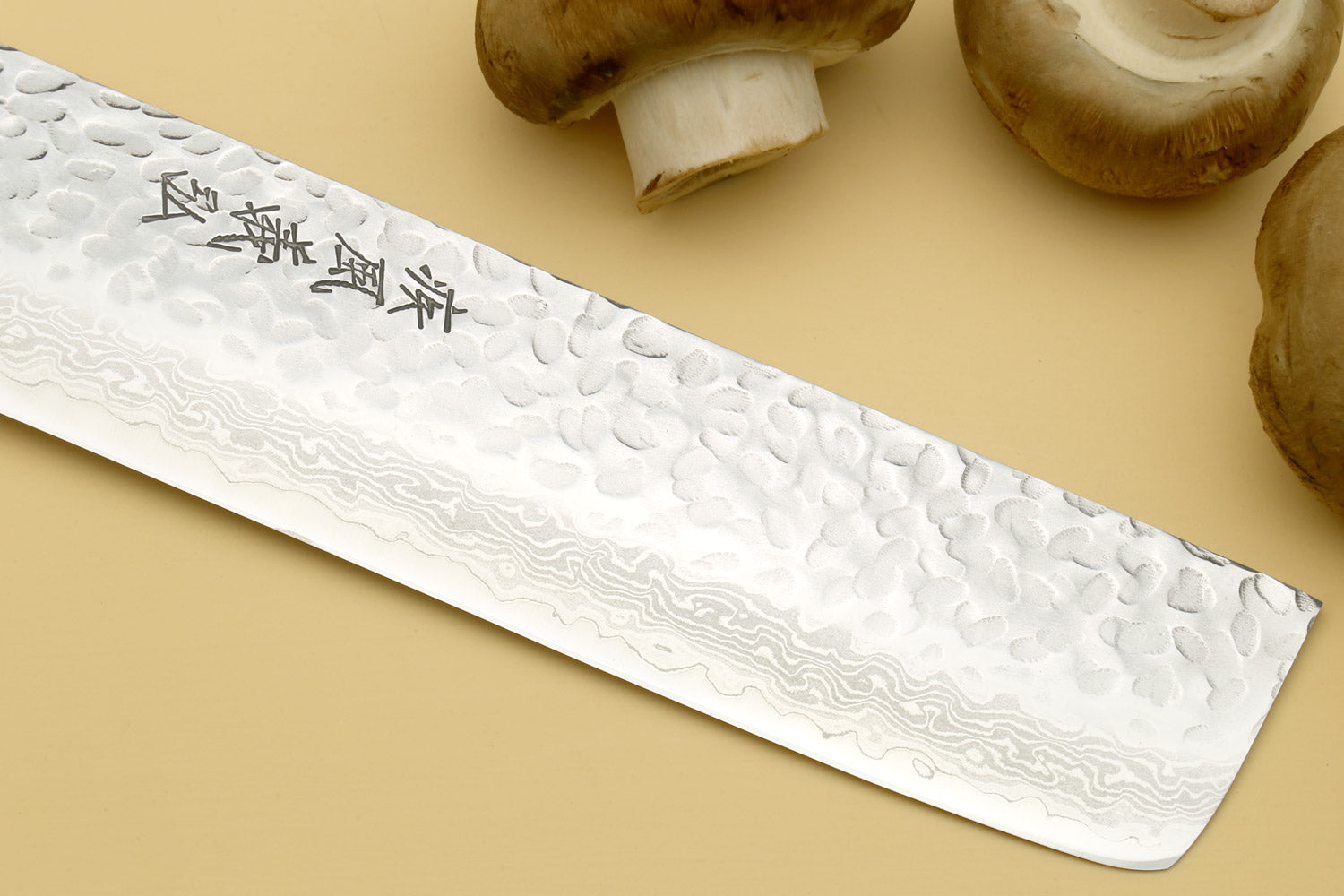 Nakiri vegetable knife side view showing hammered Damascus-style stainless blade