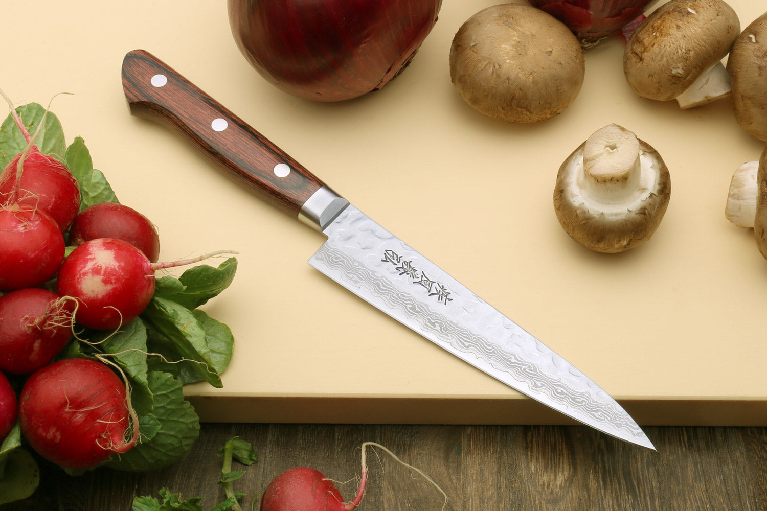 Petty knife with hammered damascus blade and dark red-brown wood handle
