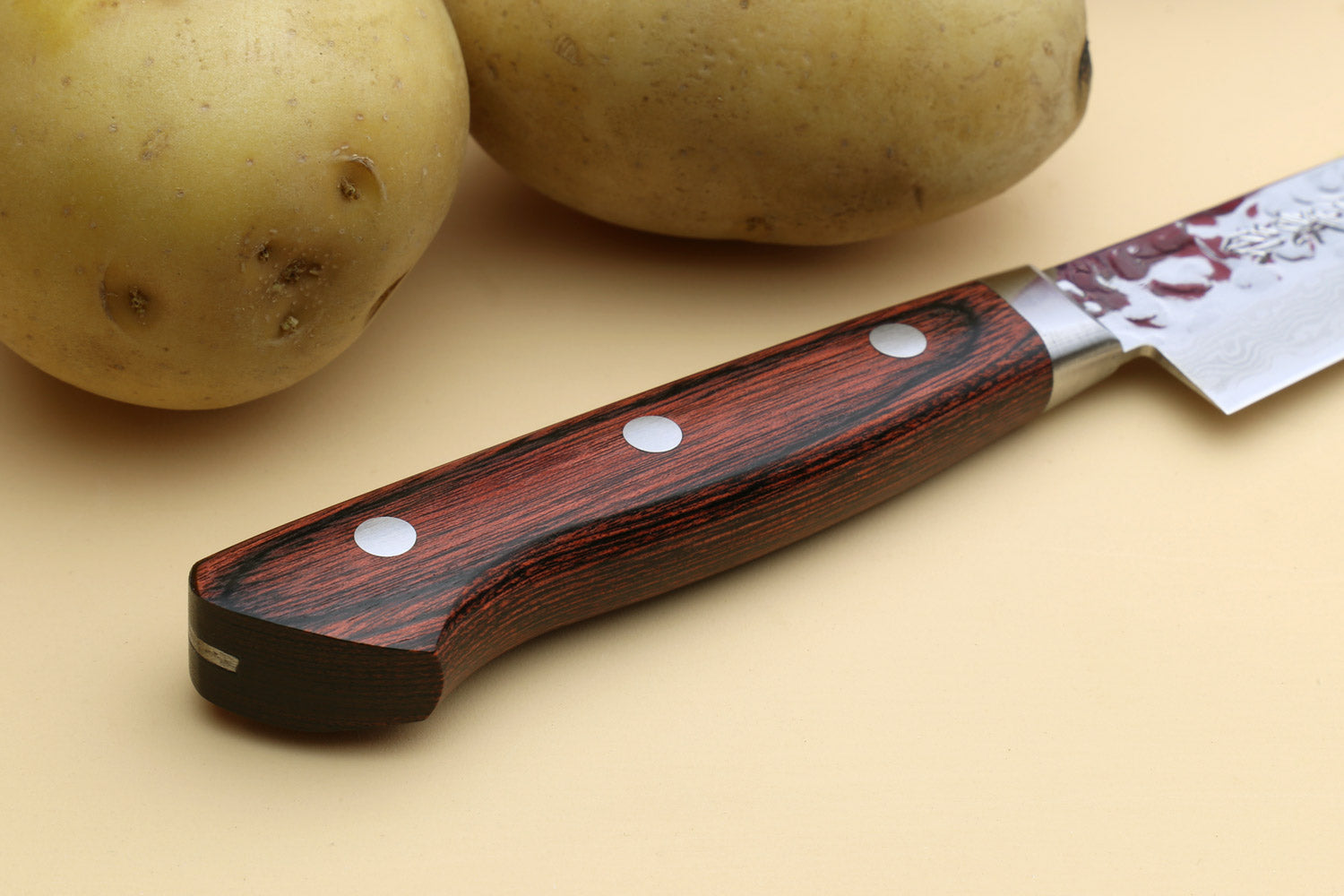 Petty knife with dark red-brown wood handle, stainless damascus blade