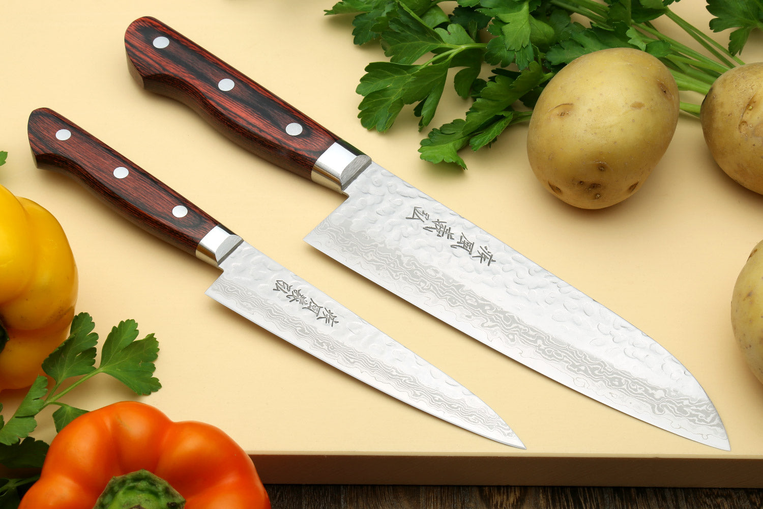 Damascus-pattern santoku knife with dark wood handle and silver bolster