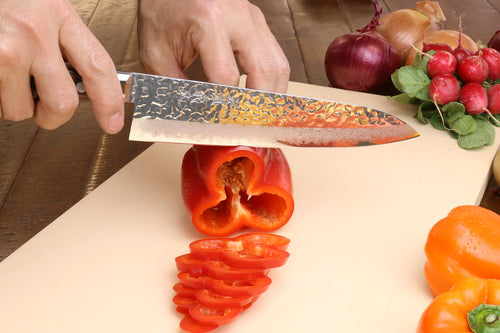 Santoku chef knife with hammered Damascus-style blade and dark red wood handle