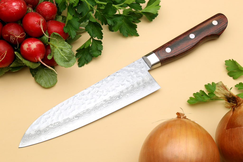 Santoku chef knife angled view with hammered Damascus-style blade and dark handle
