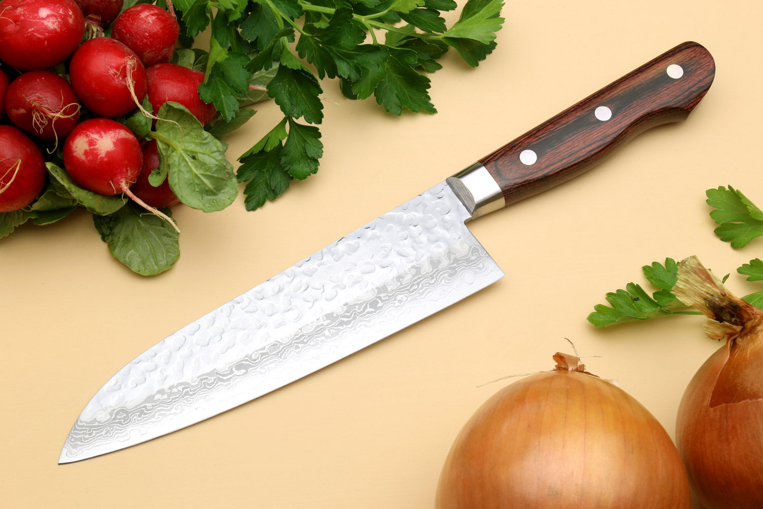 Santoku chef knife angled view with hammered Damascus-style blade and dark handle