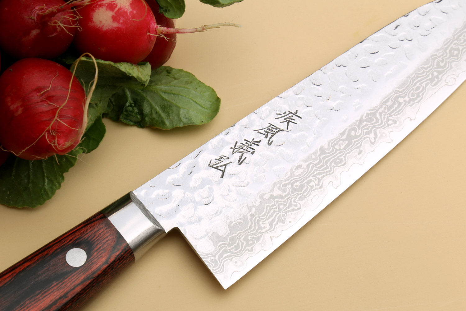 Santoku chef knife close-up of Damascus-style blade with etched markings