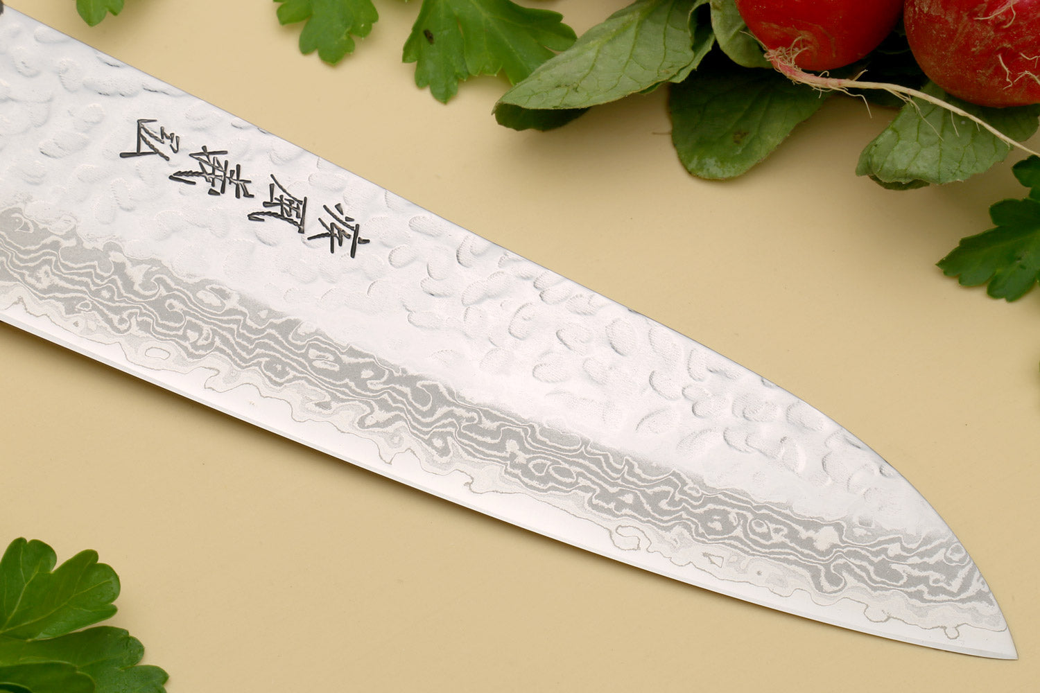 Santoku chef knife blade close-up with hammered Damascus-style texture