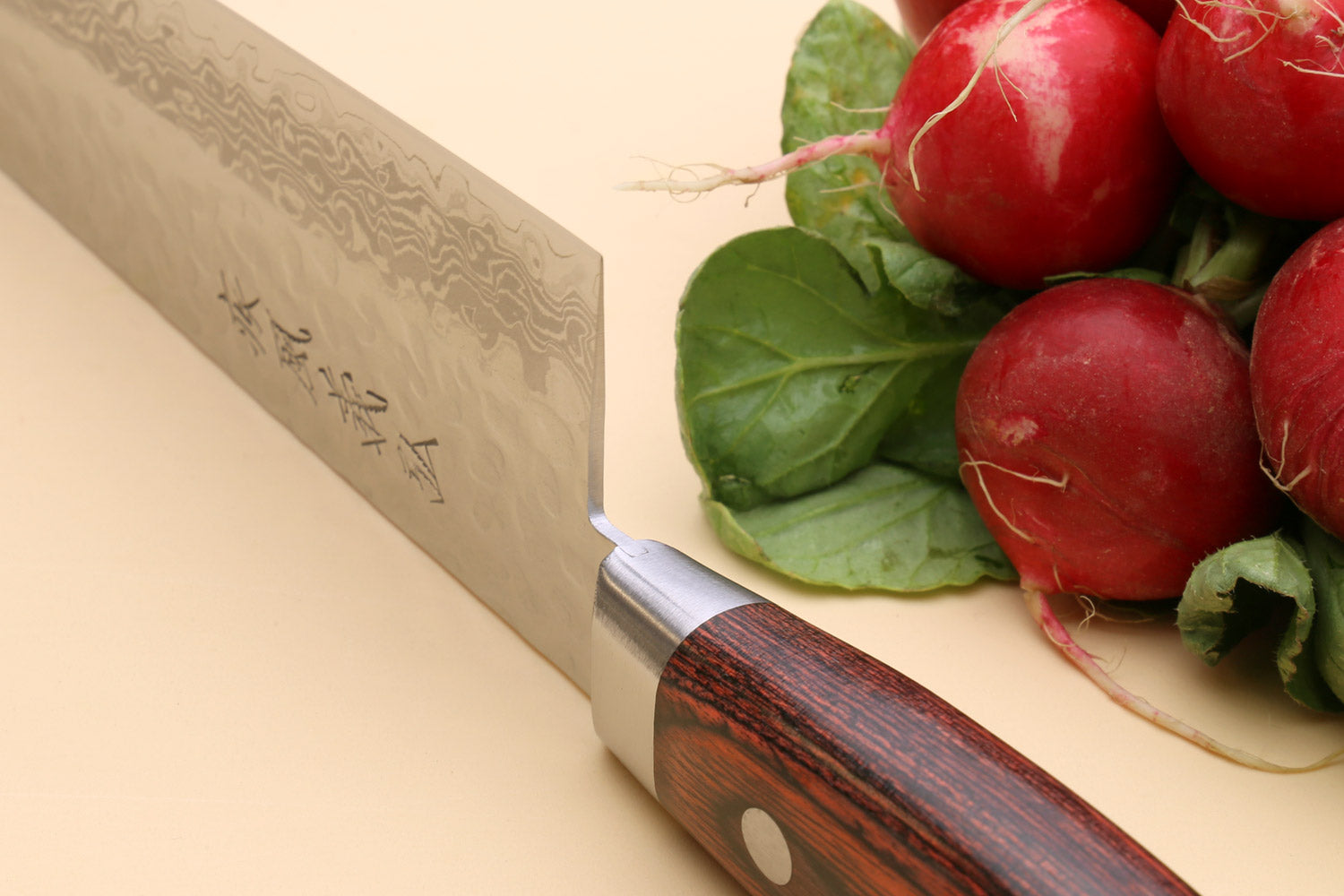Santoku chef knife side view with dark red wood handle and silver bolster