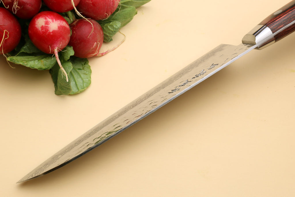 Santoku chef knife angled view with Damascus-style blade on countertop