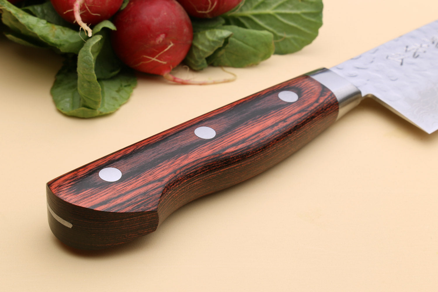 Santoku chef knife handle view with dark red wood scales and pin details