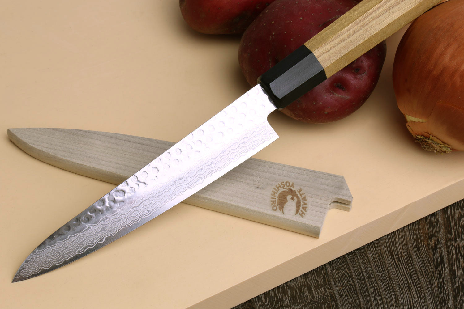 Petty utility chef knife with hammered Damascus blade and light wood handle