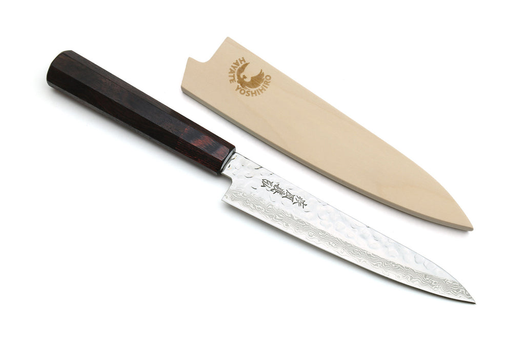 Japanese chef knife with hammered Damascus blade, rosewood handle, and wood sheath