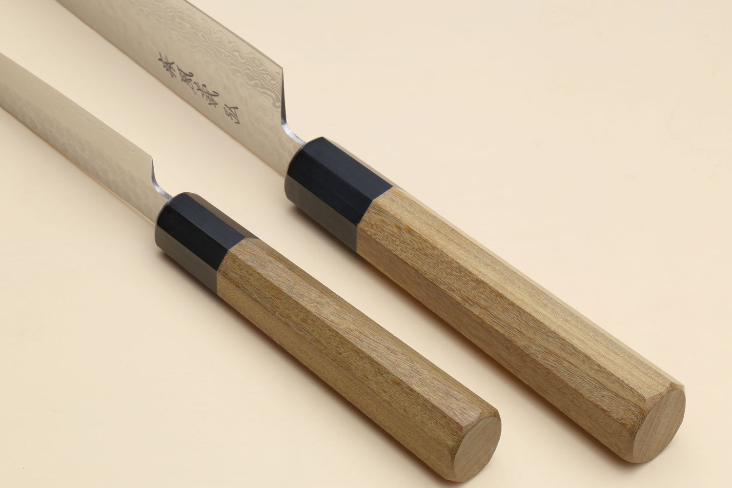 Damascus petty knife with ambrosia wooden handle and black bolster, side view