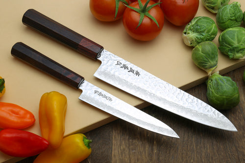 Damascus gyuto chef knife with hammered wavy blade pattern and dark wood handle