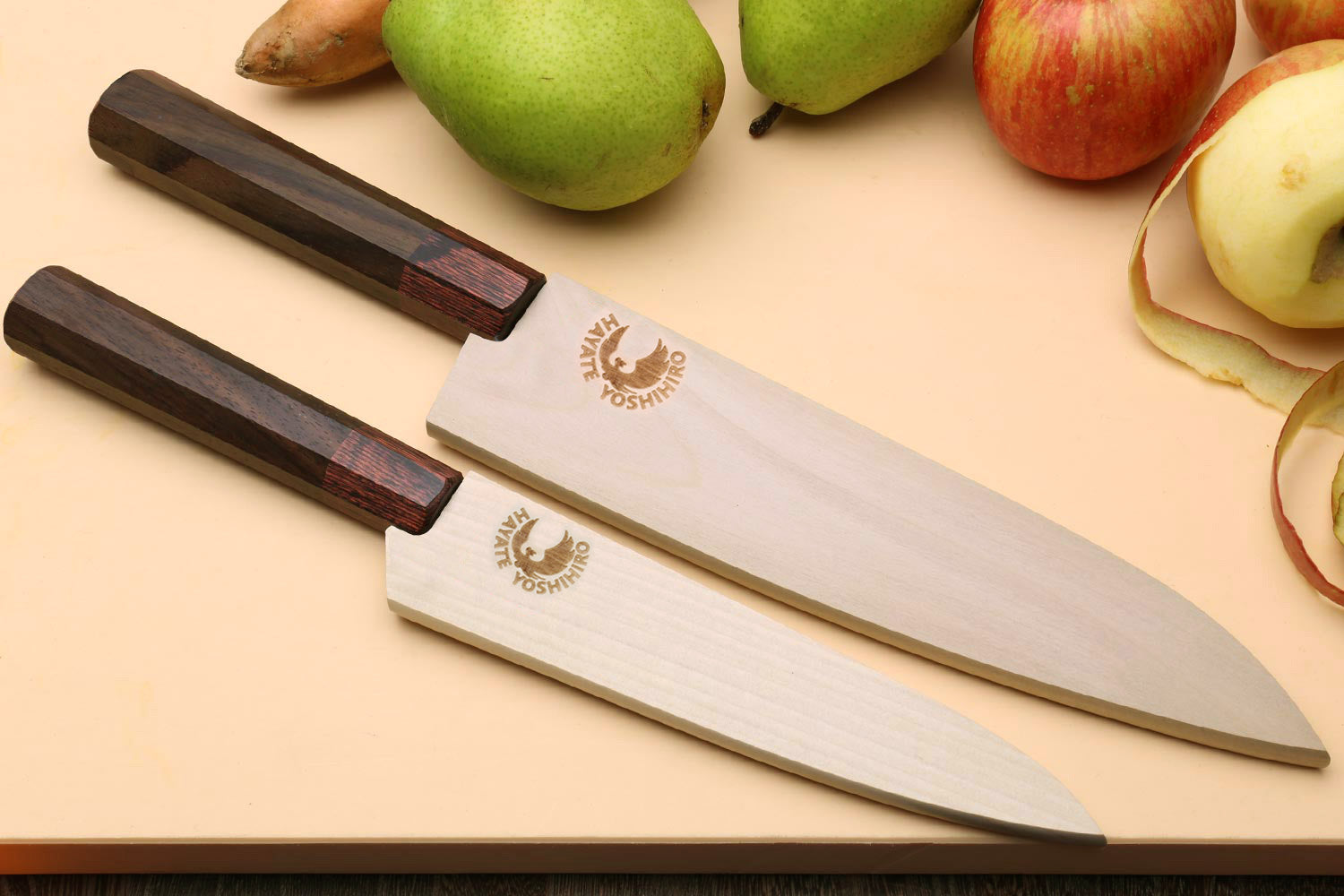 Damascus chef knife with engraved maker mark on blade and dark rosewood handle