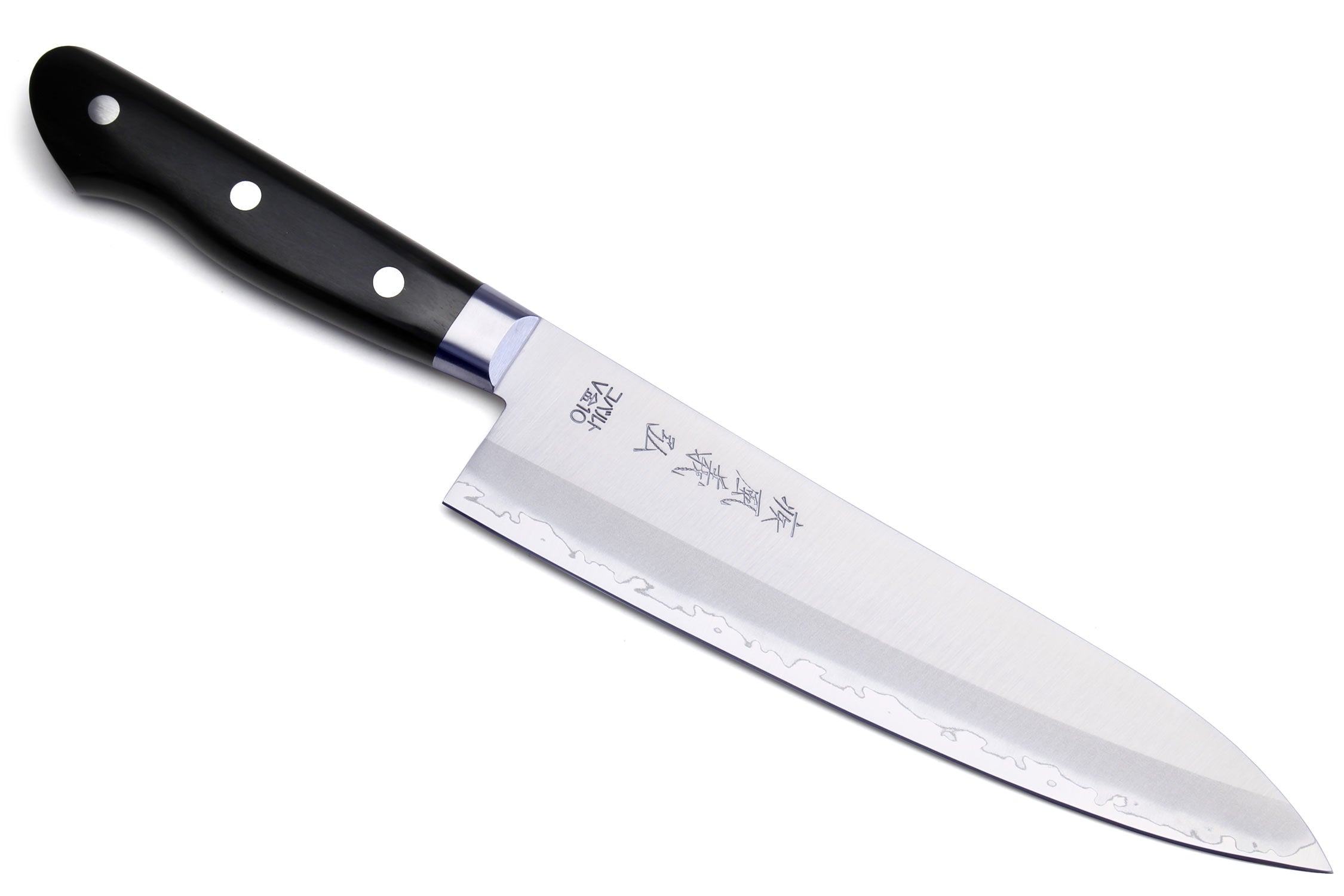 Gyuto chef knife with black handle and white steel blade, angled view.