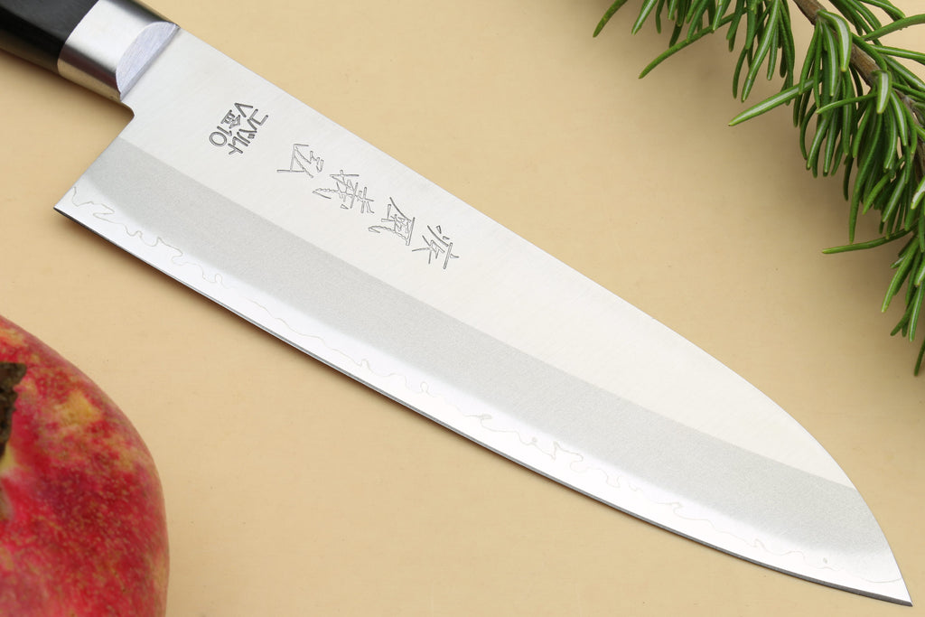 Santoku chef knife side view with silver blade and etched characters