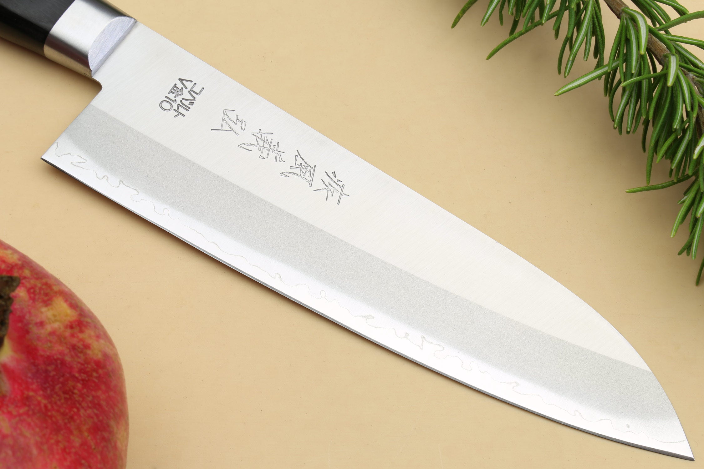 Santoku chef knife side view with silver blade and etched characters
