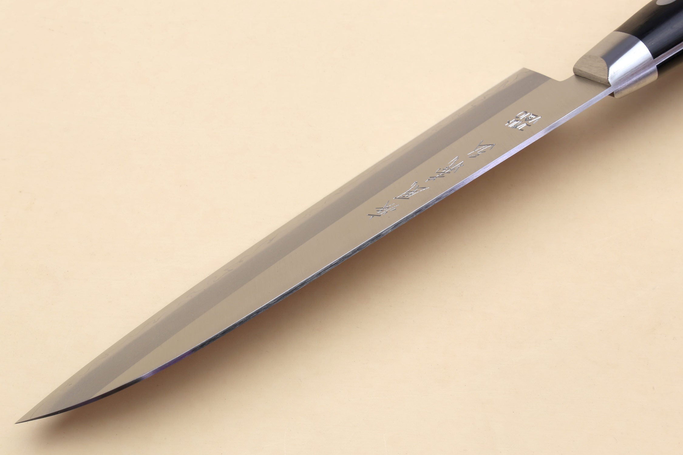 Santoku chef knife with silver blade etched markings and dark handle
